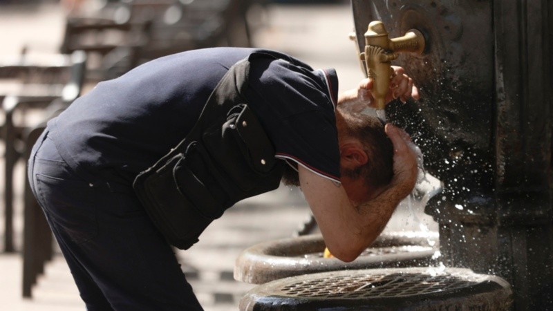 Un hombre se refresca en una fuente en el centro de Barcelona este martes.